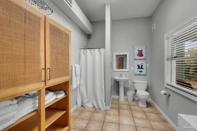 bathroom with tile patterned flooring, sink, and toilet