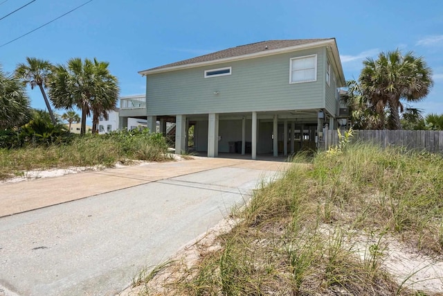 rear view of property featuring a carport