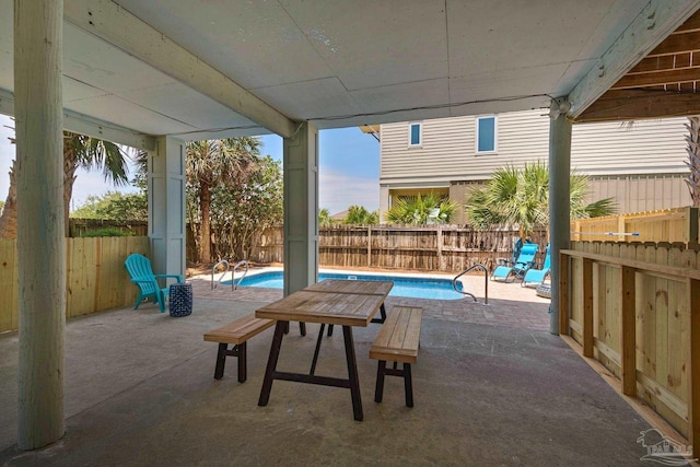 view of patio / terrace with a fenced in pool