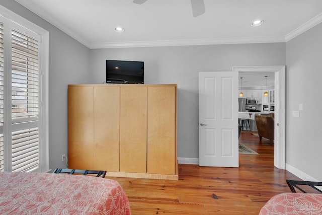 bedroom featuring crown molding and light hardwood / wood-style floors