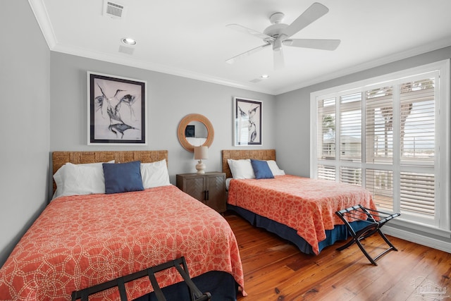 bedroom featuring crown molding, hardwood / wood-style floors, and ceiling fan