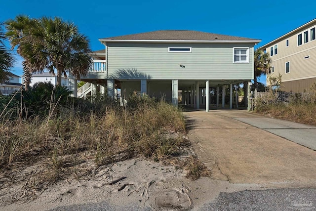 back of property with a carport