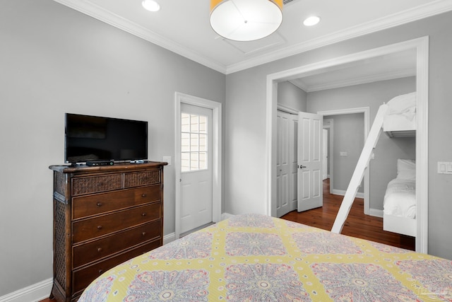 bedroom with crown molding, hardwood / wood-style floors, and a closet