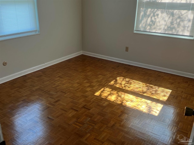 spare room with baseboards