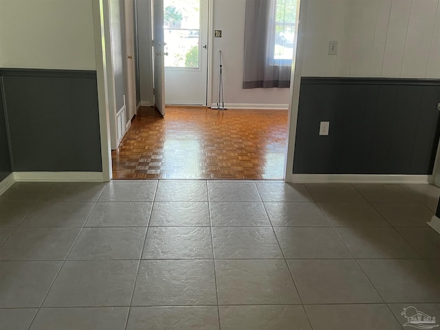 tiled foyer entrance featuring visible vents and baseboards