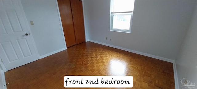 unfurnished bedroom featuring a closet and baseboards