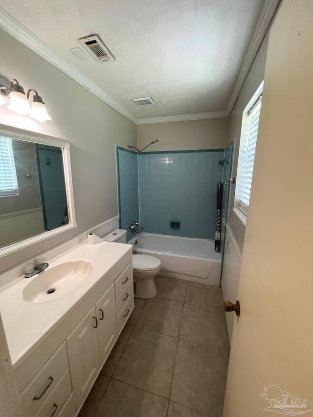 full bathroom with a wealth of natural light, vanity, toilet, and tiled shower / bath combo