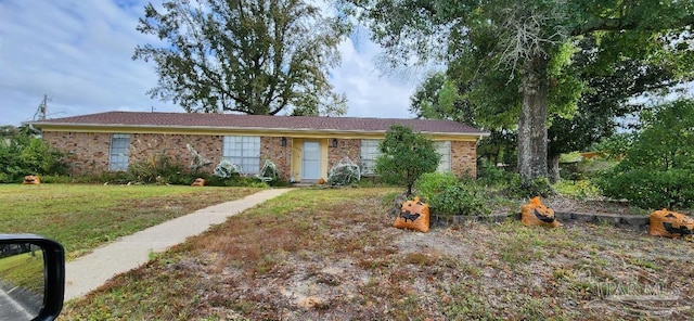 ranch-style home featuring a front yard