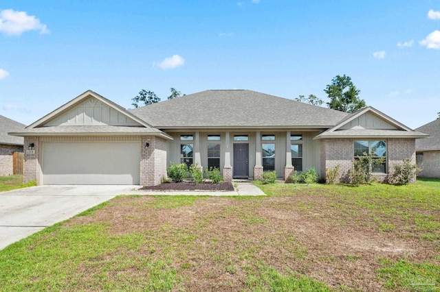 view of front of property featuring a front lawn and a garage