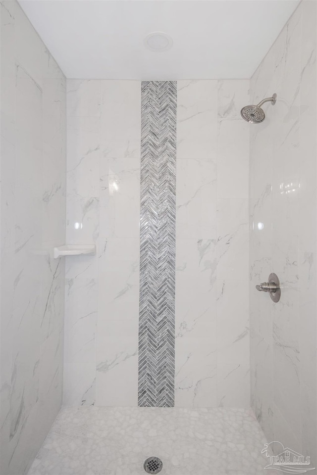 bathroom with a tile shower