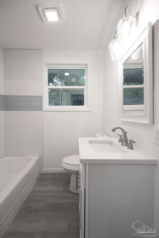 bathroom featuring vanity, hardwood / wood-style floors, and toilet