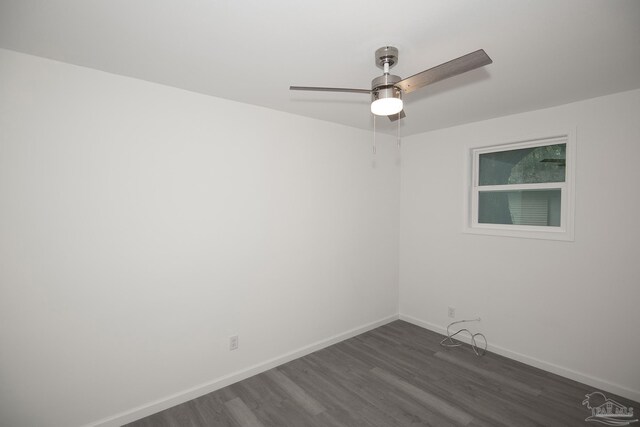 spare room with dark hardwood / wood-style floors and ceiling fan