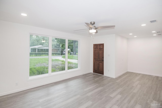 spare room with ceiling fan, light hardwood / wood-style flooring, and a healthy amount of sunlight