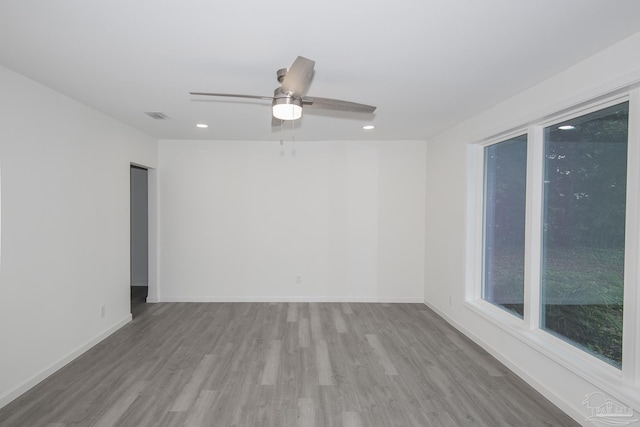 empty room with light hardwood / wood-style floors and ceiling fan