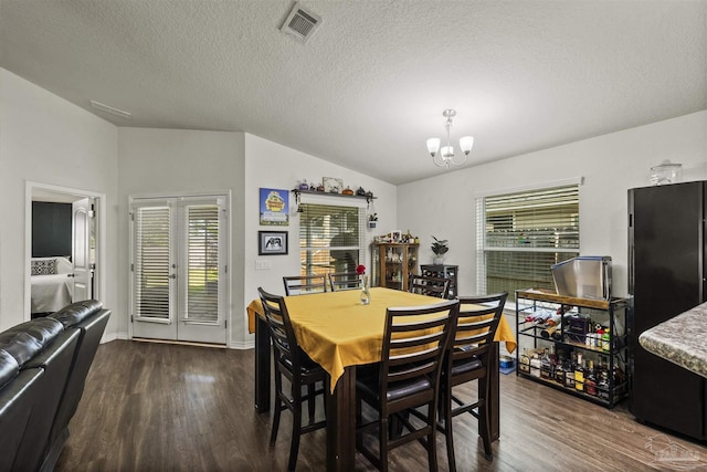 4327 Thistle Pine Ct, Pace, FL 32571 - dining space with dark wood-style floors, a chandelier, lofted ceiling, and a textured ceiling