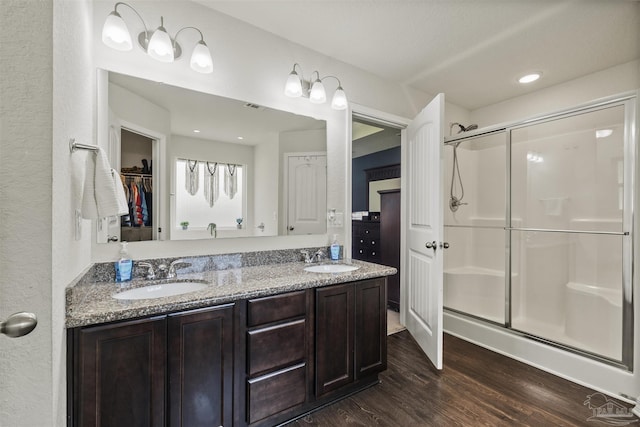 4327 Thistle Pine Ct, Pace, FL 32571 - full bath with a shower stall, wood finished floors, double vanity, a walk in closet, and a textured wall