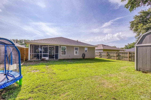 4327 Thistle Pine Ct, Pace, FL 32571 - rear view of house with a trampoline, a sunroom, a fenced backyard, and a shingled roof