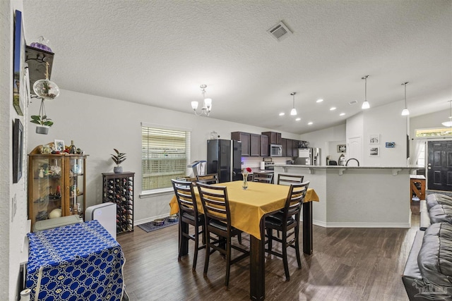 4327 Thistle Pine Ct, Pace, FL 32571 - dining room with a chandelier, dark wood-type flooring, lofted ceiling, and a textured ceiling