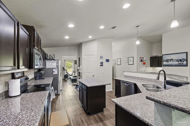 4327 Thistle Pine Ct, Pace, FL 32571 - kitchen featuring stainless steel appliances, a center island with sink, dark wood-style floors, pendant lighting, and recessed lighting
