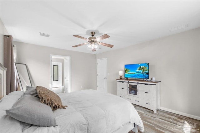 bedroom with light hardwood / wood-style flooring and ceiling fan