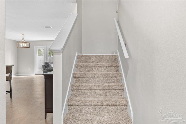 stairs featuring hardwood / wood-style floors