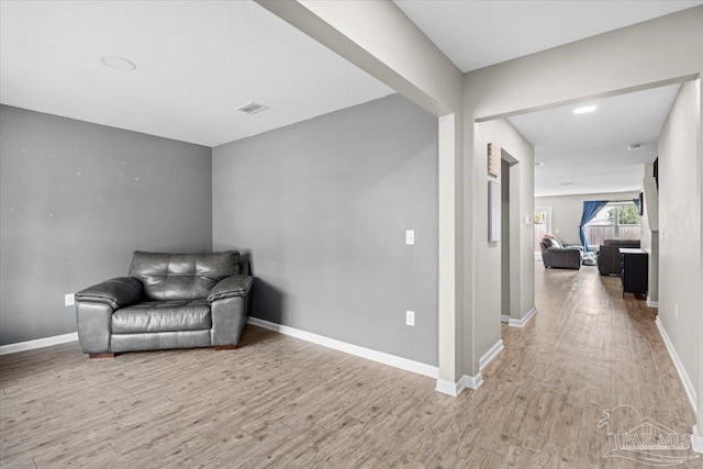 sitting room with wood-type flooring