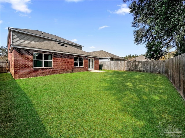 back of house with a lawn