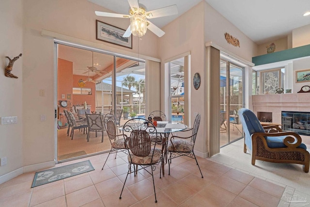 tiled dining room with vaulted ceiling and ceiling fan