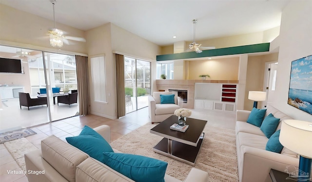 1129 Seabreeze Ln, Gulf Breeze, FL 32563 - tiled living area featuring a glass covered fireplace and ceiling fan