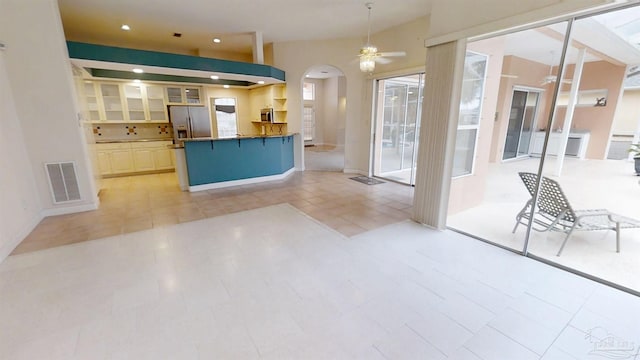 1129 Seabreeze Ln, Gulf Breeze, FL 32563 - kitchen with visible vents, ceiling fan, appliances with stainless steel finishes, arched walkways, and a kitchen breakfast bar