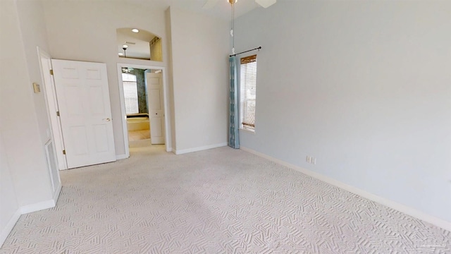 1129 Seabreeze Ln, Gulf Breeze, FL 32563 - unfurnished room featuring arched walkways, baseboards, and a wealth of natural light