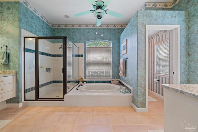 bathroom featuring ceiling fan, vanity, plus walk in shower, and tile patterned flooring