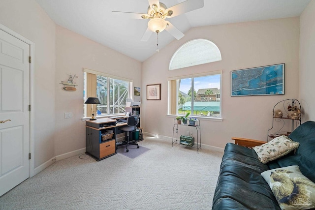 home office with ceiling fan, lofted ceiling, carpet flooring, and a healthy amount of sunlight