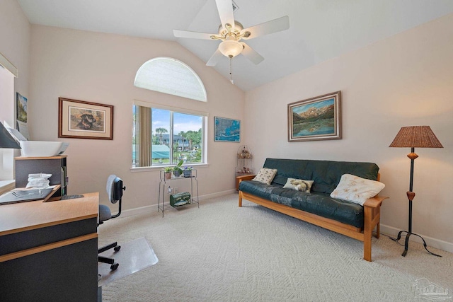 carpeted office with ceiling fan and high vaulted ceiling