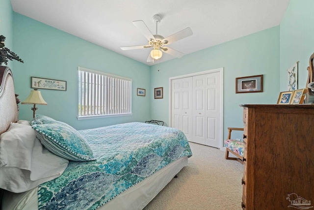 carpeted bedroom with ceiling fan and a closet