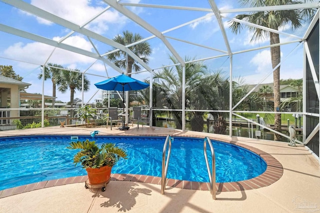 1129 Seabreeze Ln, Gulf Breeze, FL 32563 - outdoor pool featuring glass enclosure and a patio area