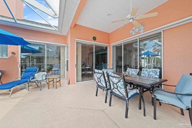 1129 Seabreeze Ln, Gulf Breeze, FL 32563 - view of patio / terrace featuring glass enclosure, outdoor dining area, and a ceiling fan