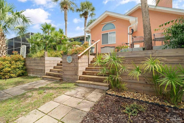 1129 Seabreeze Ln, Gulf Breeze, FL 32563 - exterior space featuring glass enclosure, stucco siding, and stairway