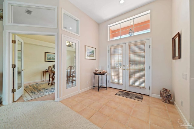 foyer entrance featuring french doors and light tile patterned flooring