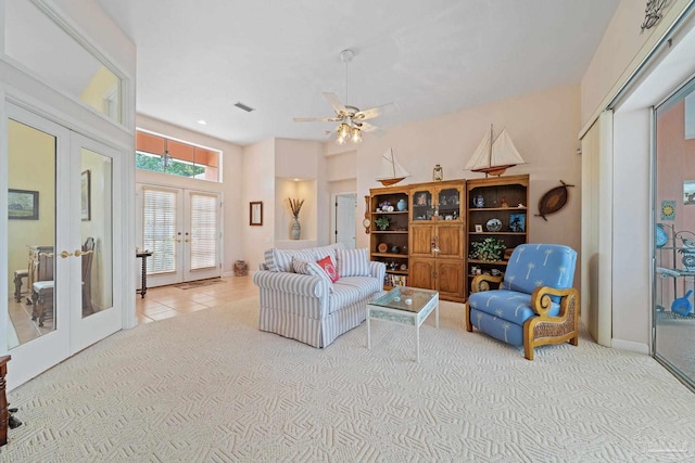 carpeted living room featuring ceiling fan and french doors