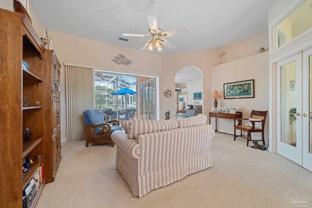 carpeted living room featuring ceiling fan