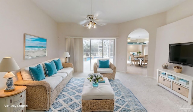 1129 Seabreeze Ln, Gulf Breeze, FL 32563 - living room with baseboards, arched walkways, a ceiling fan, and light colored carpet