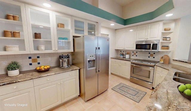 1129 Seabreeze Ln, Gulf Breeze, FL 32563 - kitchen featuring white cabinetry, stainless steel appliances, backsplash, and open shelves