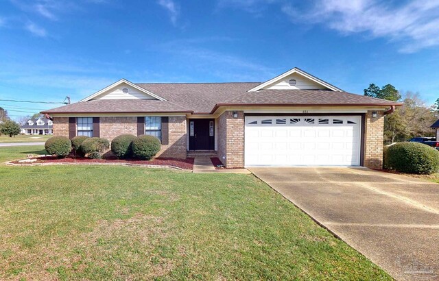 single story home featuring a garage and a front yard