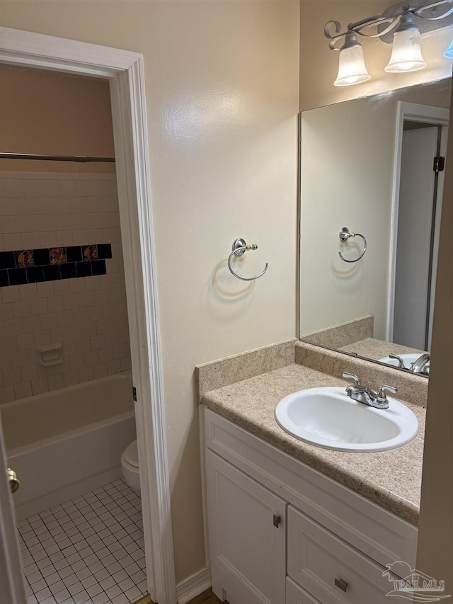 full bath featuring vanity, tile patterned floors, toilet, and bathing tub / shower combination