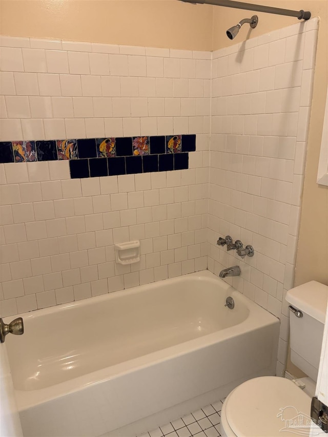 bathroom with tile patterned floors, toilet, and bathing tub / shower combination