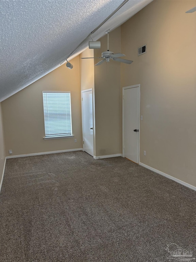 bonus room with vaulted ceiling, carpet flooring, visible vents, and a textured ceiling