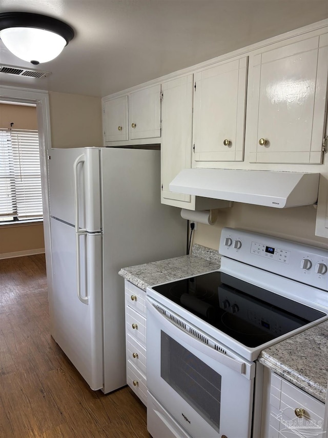 kitchen featuring white appliances, visible vents, dark wood-type flooring, white cabinets, and exhaust hood