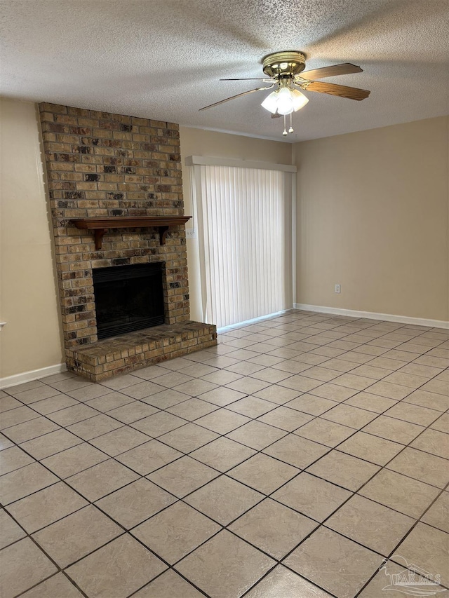 unfurnished living room with baseboards, a textured ceiling, a fireplace, and a ceiling fan