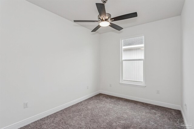 carpeted empty room featuring ceiling fan